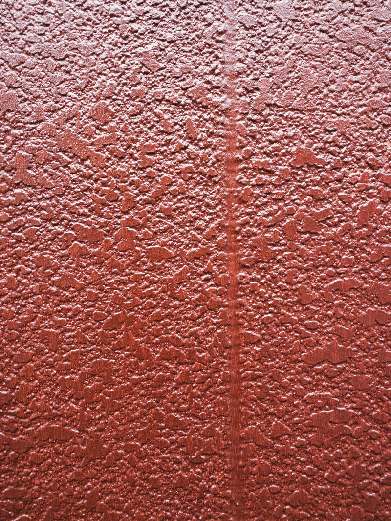 「茶色にペイントされたモルタル壁（テクスチャ）」の写真