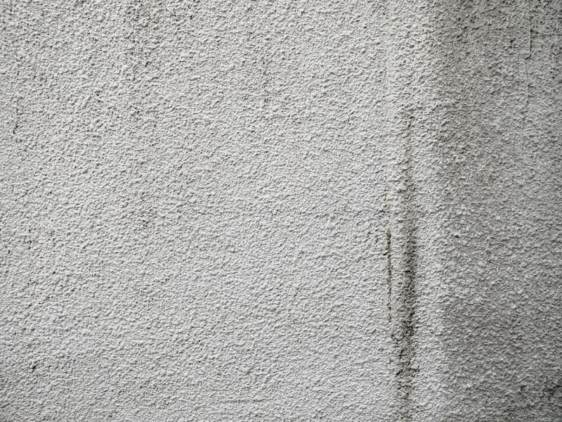 薄汚れたモルタル壁（テクスチャ）の写真