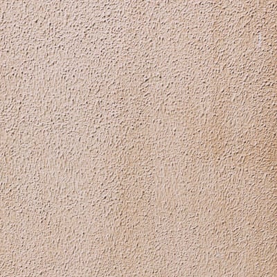 茶色くシミが浮かぶモルタル壁（テクスチャ）の写真