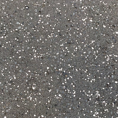 白い粒が散らばる路面（テクスチャー）の写真