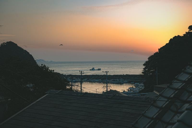 朝焼けに染まる三重県答志島の漁港の写真