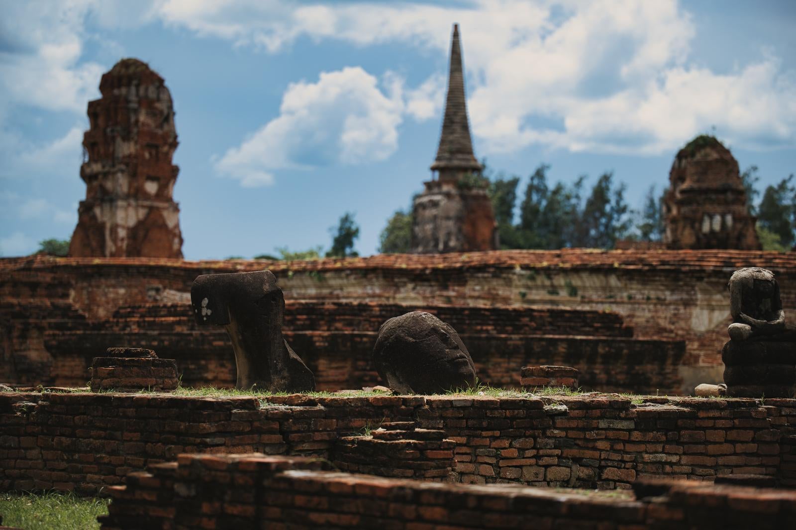 Weathered Buddha Heads and Brick Ruins Beneath the Blue Sky - free stock photo