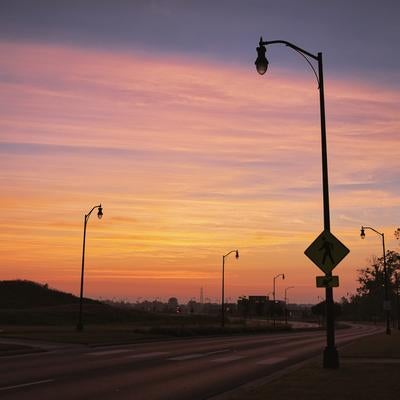 初夏の朝焼けと街灯のシルエットの写真