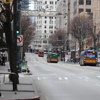 大通りに並ぶバスとシアトルの街並みの写真