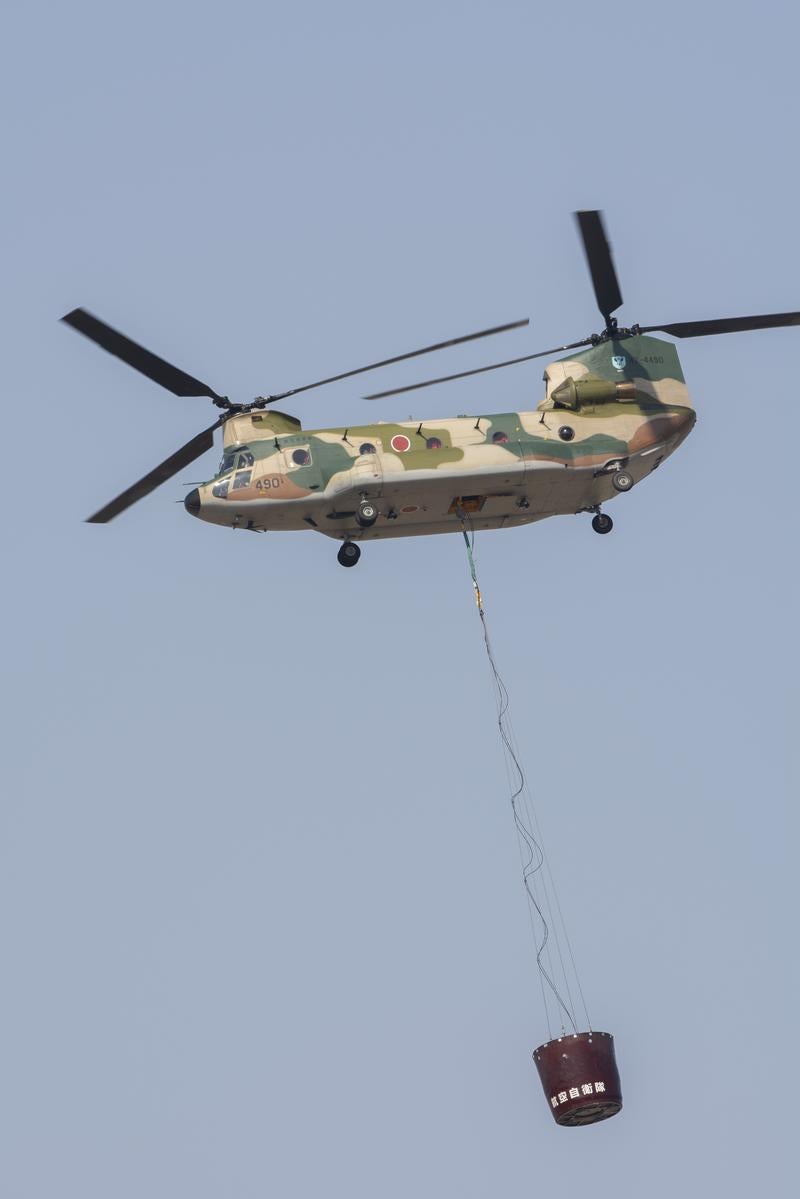 Japan Self-Defense Force Helicopter Performing Firefighting Operations by Suspending a Water Bag